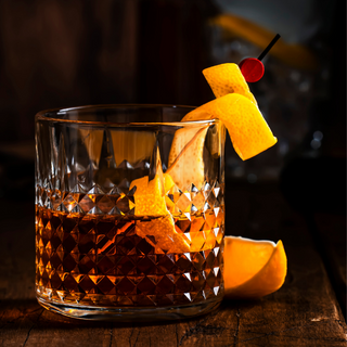 Whiskey glass with whiskey and citrus peels